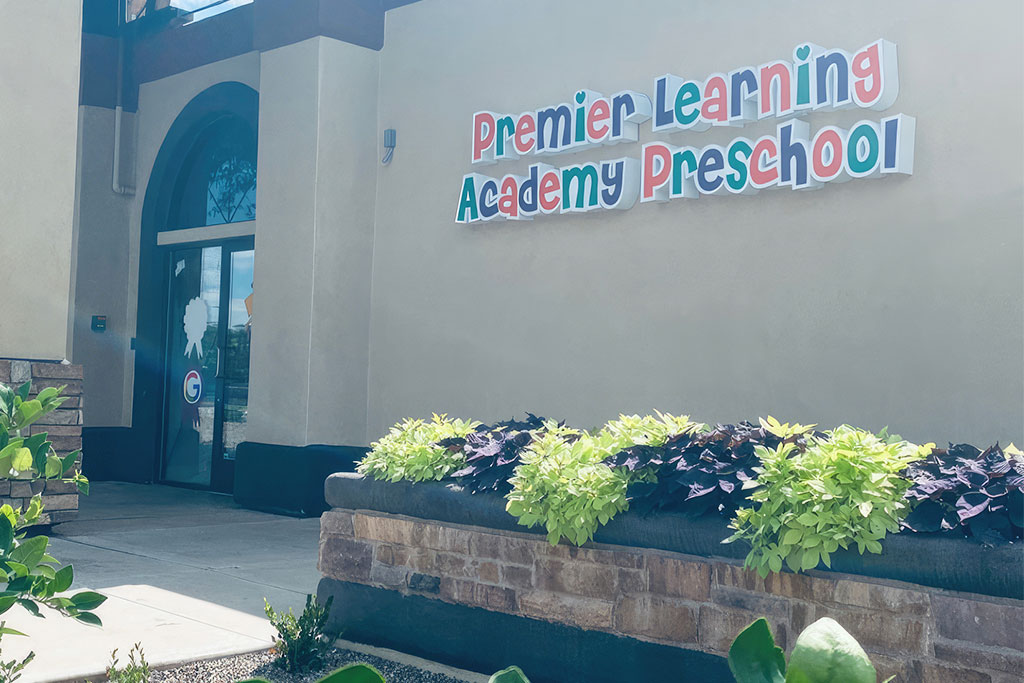 Exterior view of Premier Learning Academy Preschool, featuring the colorful sign above the entrance with well-maintained landscaping.